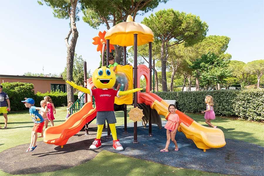 Children with the Mascot playing at the Pappasole Camping Village playground